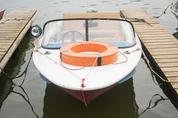 Boat on the pier. Rescue boat at the boat station. Lifebuoy on board the vessel.