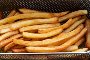 French fries in a deep fryer basket