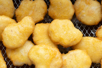 fried chicken nuggets in deep fryer basket