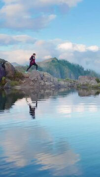 A hiker treks across rocky terrain with a mountain and its reflection in a lake, symbolizing outdoor adventure, nature, hiking, and tranquility in a serene and peaceful setting