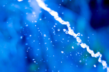 blue abstract background with glowing water splash effect