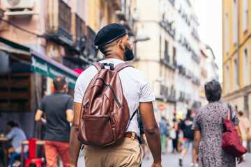 Stylish black man walking on the city street