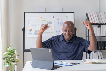 Creative african businessman senior american worker using computer device in office,chat online,...