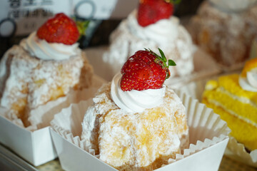 Strawberry cakes in paper box on shelf in bakery shop