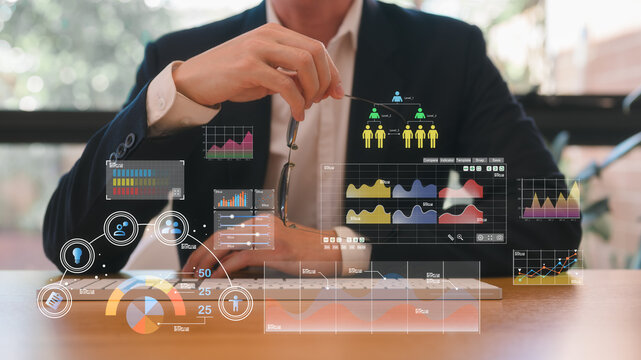 Businessman or an analyst uses a computer and dashboard for data business analysis and Data Management System with KPI and metrics connected to the database for technology