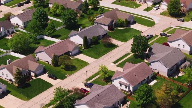 Peaceful aerial view of a suburban neighborhood in the usa. Neat houses and green lawns perfect, real estate and urban living concepts