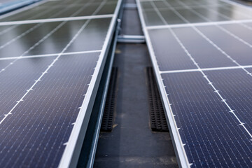 Photo solar panels install on a flat commercial, industrial EPDM roof, with concrete ballast blocks.	