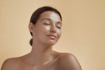 Photo of Natural Beauty Woman with Radiant Tanned Skin and Closed Eyes