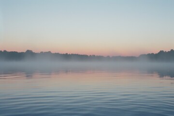 Fototapeta premium Peaceful dawn at a tranquil lake with mist gently rising from still water. Serene landscape concept