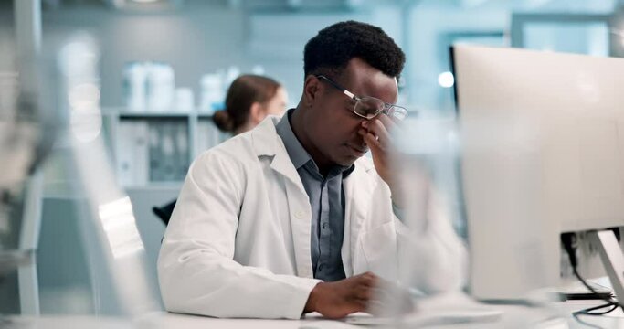 Scientist, computer and black man with headache in lab for medical research, anxiety and brain fog. Science, frustrated and stress with digital technology for stem cell, vaccine study and fatigue