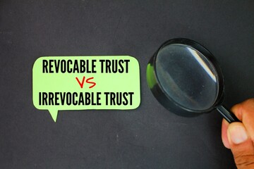 magnifying glass and colored paper with the words Irrevocable Trust vs Revocable Trust