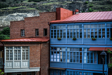 The view on the houses in old part of Tbilisi with rocks behind on a background