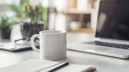 Obraz premium Minimalist workspace with coffee mug, laptop, and notebook.