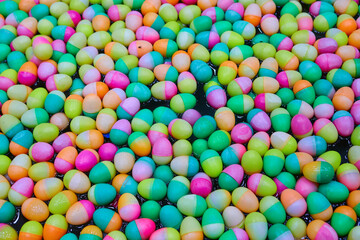 Full frame shot of multicolored charity raffle balls are floating in the tub