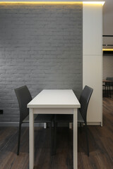 Kitchen table with two chairs in the kitchen interior
