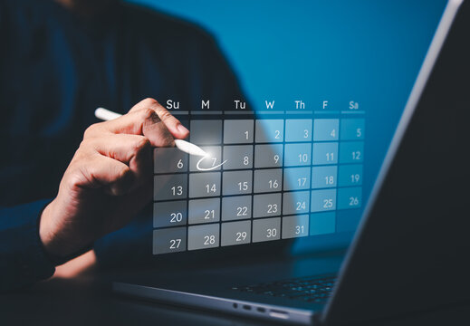 Secretary uses a computer with virtual calendar screen to make appointment reminders or meeting agenda on the calendar. Time management concept. People manage schedule agenda for time-effective work.