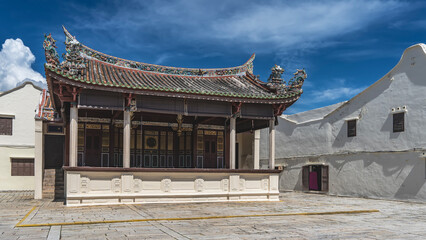 The building of an ancient Chinese-style theater. A scene with columns. The walls  with golden...