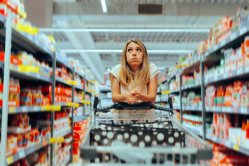 Confused Client Thinking What to Buy in a Supermarket. Buyer deciding about purchases in a big...