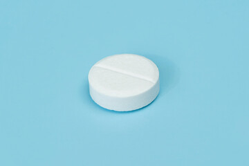 Pharmacy healthcare concept. Close up of white pill on blue background. the concept of health medicine and pharmacy. Production of medicines.