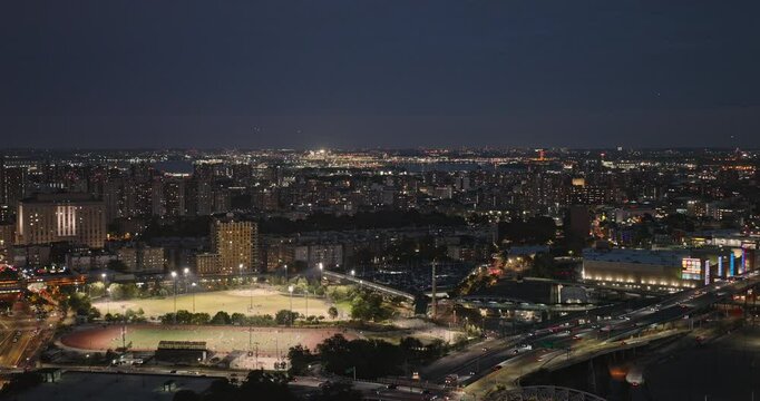NYC New York Aerial v261 drone flyover Bronx capturing sports field, retail complex, traffics on Macombs Dam expressway and cityscape of Mott Haven at night - Shot with Inspire 3 8k - September 2023