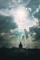 Fototapeta premium Person in field with cloudy sky