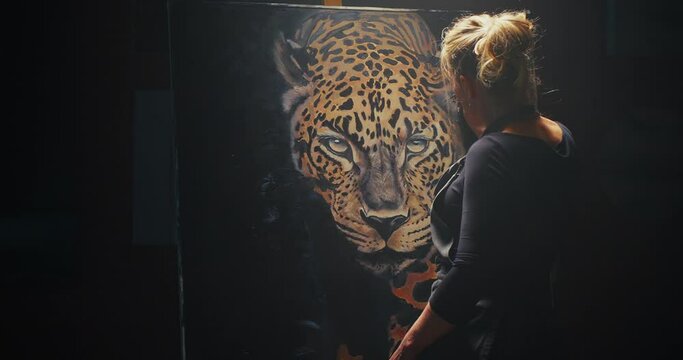 Woman Painting Leopard on Canvas