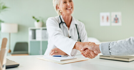 Happy woman, doctor and handshake with patient for consultation, agreement or checkup at hospital. Female person or medical professional shaking hands with client for meeting, deal or appointment