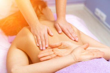 Top view of hands massaging female abdomen.Therapist applying pressure on belly. Woman receiving massage at spa salon