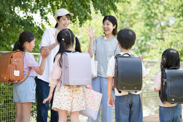 Japanese elementary school students and their parents, being picked up and dropped off by the...