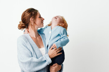Mother and daughter embracing in front of white background in fashion and beauty concept
