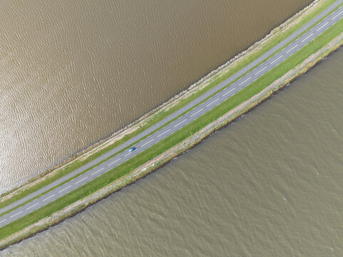 Driving road at the Markermeer, road running through lake