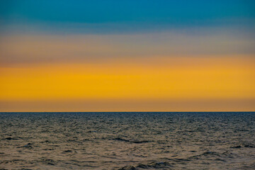 Enjoy a panoramic view of the skyline. The sun rises in the morning sky with colorful clouds. and beautiful cloud patterns In the soft light of the morning at sea
