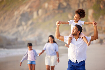 Family, father and girl on shoulders or beach fun on holiday, bonding and walking on sea shore or...