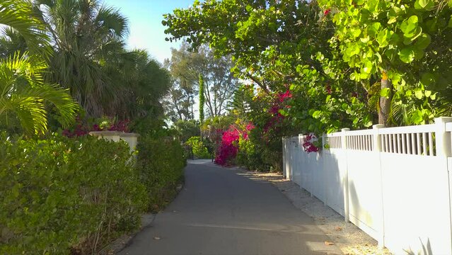 Casey Key coastal residential community picturesque street. Car point of view driving on scenic road in sunny Florida.