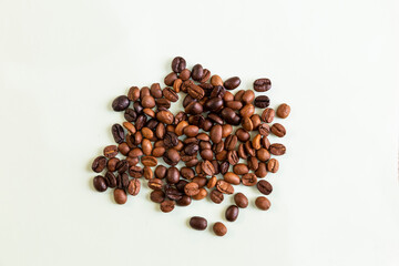 Roasted coffee beans on a white background implying the concept of coffee trade and business in prefect details.