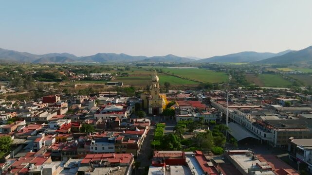 Reverse aerial flight unveils scenic panoramic views of Tamazula city and surrounding landscapes. Jalisco, Mexico