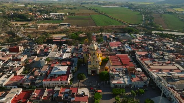 Aerial dolly in, tilt down of Santuario Diosesano church in rural Tamazula, Mexico