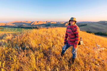 portrait of a beautiful mature woman traveling through the mountains of the Southern Urals on a summer sunny day