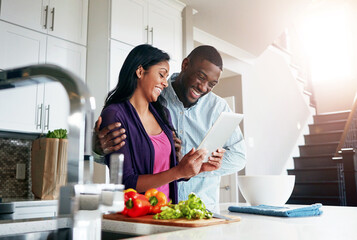 Couple, tablet and cooking in kitchen together, online recipe and vegetables for nutrition dinner. People, marriage and ingredients for food in home, bonding and meal prep website for instructions