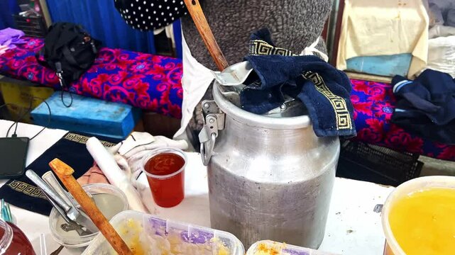 pure natural honey transferring into a plastic bottle in the market, world oldest Silk Road Market in Samarkand District, Siab Bazaar, largest bazaar in Samarkand, domestic and foreign tourists.