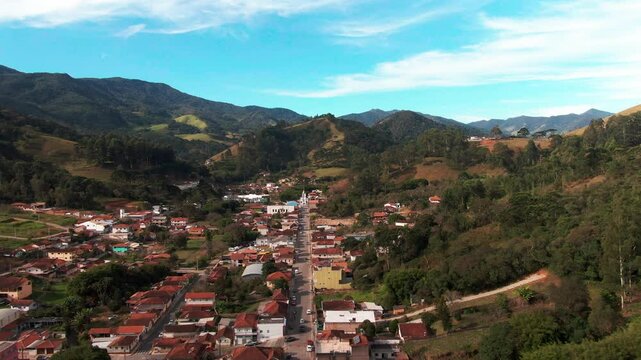Stunning aerial footage showcasing the charming town of Delfim Moreira nestled amidst the rolling hills of Minas Gerais, Brazil.