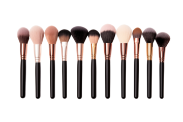Set of professional makeup brushes arranged neatly, isolated on transparent background.