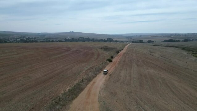 Ute driving on dusty road in the countryside