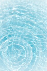Blue water with ripples on the surface. Defocus blurred transparent blue colored clear calm water surface texture with splashes and bubbles. Water waves with shining pattern texture background.	