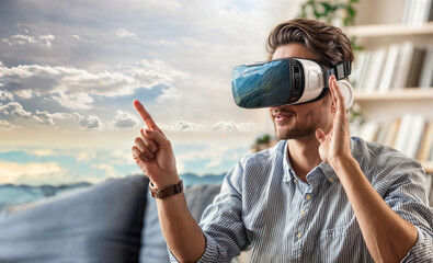 A young man wearing a virtual reality headset, gesturing with their hand while exploring a digital environment