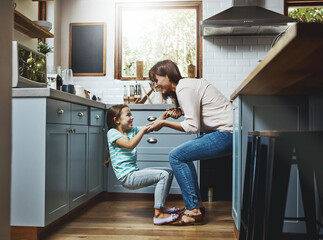 Excited, daughter and woman with playing in kitchen for weekend fun, love and bonding in childhood....