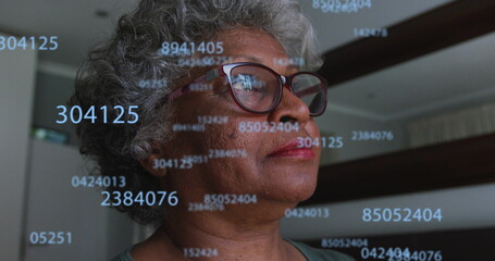 Image of numbers over senior african american woman