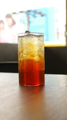 Blurred red and yellow bokeh with water drops. Condensation on glass of iced tea