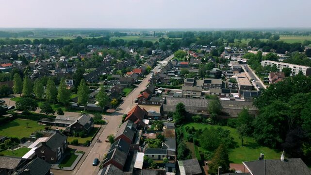 Aerial view of Budel city centre focusing on Mathijsenstraat in the village of Brabant. The footage captures the heart of the town, showcasing its streets, buildings, and local life. Location: Budel