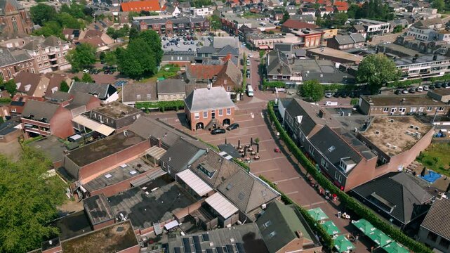 Fixed drone shot view of the center of Budel village in Cranendonck, Brabant during spring. Captures the quaint charm and lush greenery of the area. Budel, Cranendonck, Brabant, The Netherlands